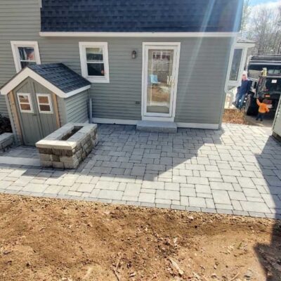 Installation in progress for a custom hardscape stone patio by Willie C. & Sons Landscaping.