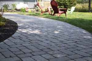 Custom curved walkway installed by Willie C. & Sons Landscaping for a residential property in Maine.