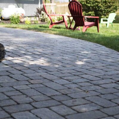 Custom curved walkway installed by Willie C. & Sons Landscaping for a residential property in Maine.
