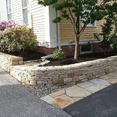 Tiered retaining wall for a flower garden built by Willie C. & Sons Landscaping for a home on a corner.