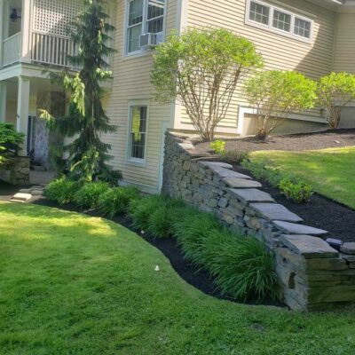 Lush landscape installation and lawn care in Falmouth, Maine by Willie C. & Sons Landscaping.