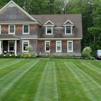 Lush new front lawn installation for a Maine home by Willie C. & Sons Landscaping.